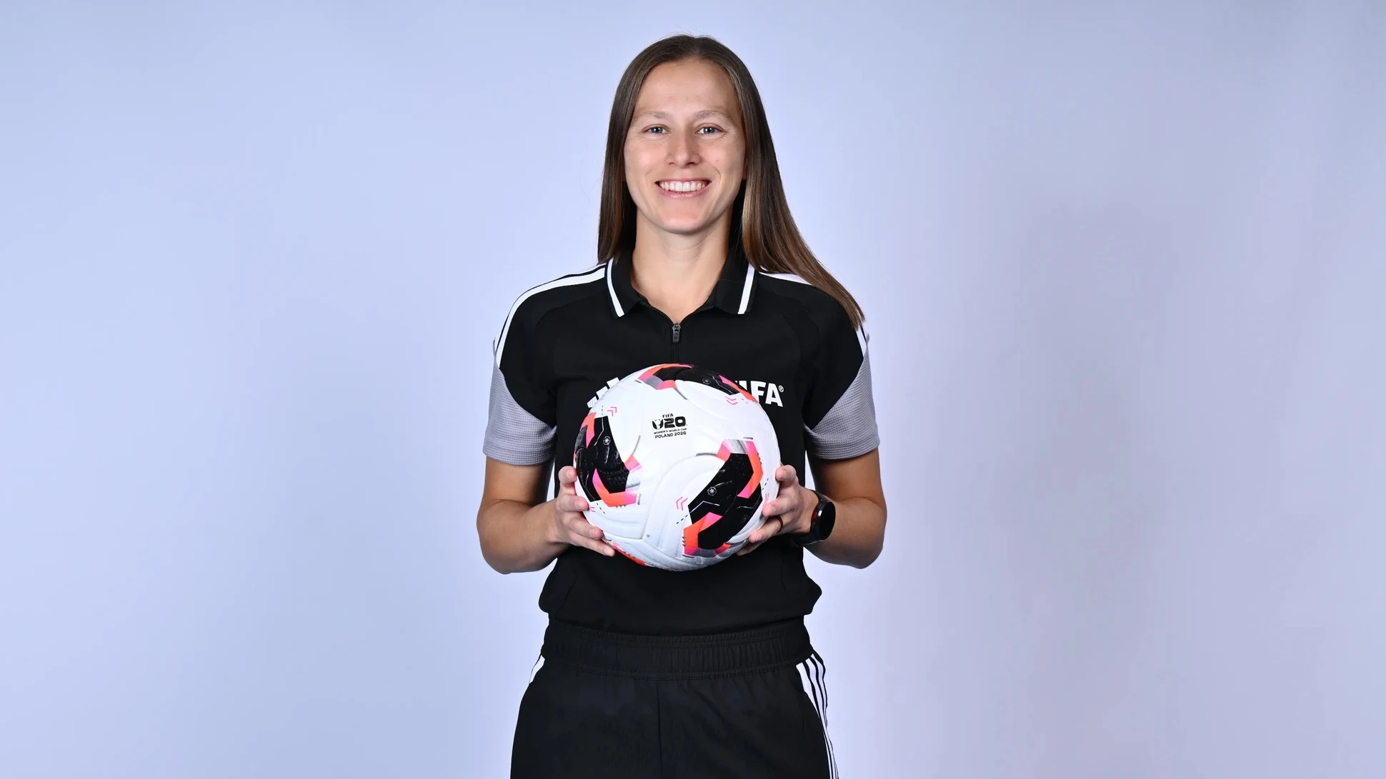 A referee holding a football
